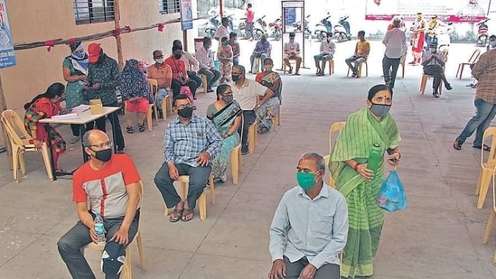People wait outside a Covid-19 vaccination centre in Pune on Friday. (Ravindra Josh/HT Photo ) People wait outside a Covid-19 vaccination centre in Pune on Friday. (Ravindra Josh/HT Photo )