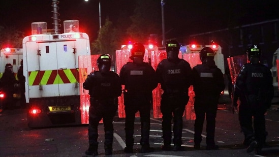 Belfast: Police form a line to separate Nationalists from attacking each other in North Belfast, Northern Ireland, Friday, April 9, 2021. (AP)