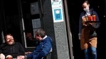 A waitress serves drinks at a cafe in the Soho area of London, Monday, April 12, 2021, as restaurants, bars and pubs can open and serve people who can be seated outside. Millions of people in England will get their first chance in months for haircuts, casual shopping and restaurant meals on Monday, as the government takes the next step on its coronavirus lockdown-lifting road map. (AP)