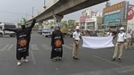 Policemen wearing dress themed on Covid-19 coronavirus and holding a gigantic facemask urge commuters to wear facemasks during an awareness campaign at a traffic junction in Hyderabad on April 9, 2021, as India surged past 13 million coronavirus cases. (AFP) Policemen wearing dress themed on Covid-19 coronavirus and holding a gigantic facemask urge commuters to wear facemasks during an awareness campaign at a traffic junction in Hyderabad on April 9, 2021, as India surged past 13 million coronavirus cases. (AFP)