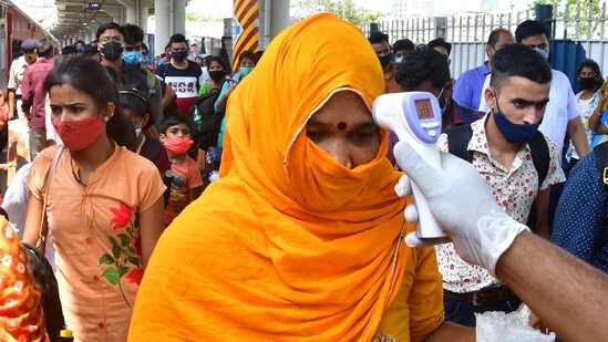 A traveller undergoes thermal screening at Dadar Railway Station, in Mumbai, on April 12. The active cases in India also crossed the 12-lakh mark, while the death toll increased to 1,70,179 with 904 new fatalities reported on April 12, the highest since October 18, 2020, PTI reported citing Union Health Ministry data.(Bhushan Koyande / HT Photo)