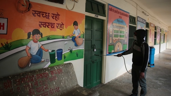 A volunteer disinfects the premises at Seth Anandilal Poddar Government Deaf And Dumb School in Jaipur, Rajasthan. (Himanshu Vyas/ Hindustan Times)