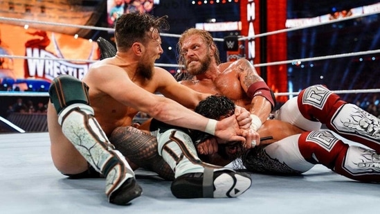 Edge and Daniel Bryan lock their submission on Roman Reigns at WWE WrestleMania 37.(WWE)