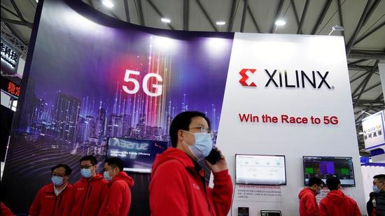 Staff members stand at a Xilinx Inc booth at the Mobile World Congress in Shanghai, China. (REUTERS)