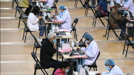 People registering information before receiving a vaccine against the Covid-19 coronavirus in Nanjing, in China's eastern Jiangsu province. (AFP) People registering information before receiving a vaccine against the Covid-19 coronavirus in Nanjing, in China's eastern Jiangsu province. (AFP)