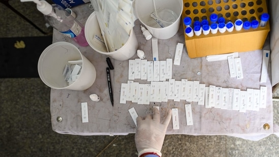 A health worker tests swab samples collected for coronavirus detection, at Nizamuddin Railway Station, in New Delhi, on April 11. According to the ICMR, 25,78,06,986 samples have been tested in India up to April 11.(Amal KS / HT Photo)