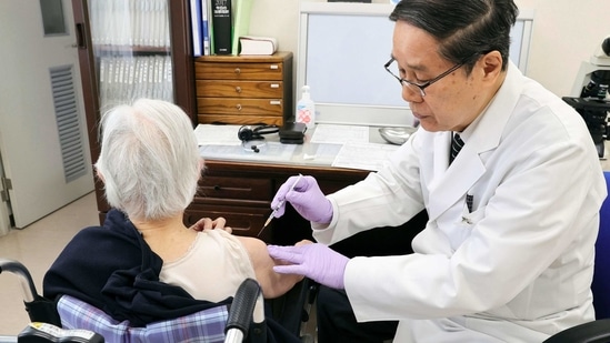 An elderly woman receives her first dose of Pfizer's COVID-19 vaccine at a special nursing home in Nagasaki, southwestern, Japan, Monday, April 12, 2021. (AP)