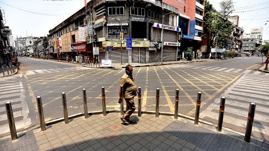 A man walks along a deserted street during a weekend lockdown imposed by the state government amidst rising Covid-19 coronavirus cases, in Pune on April 10, 2021. (AFP)