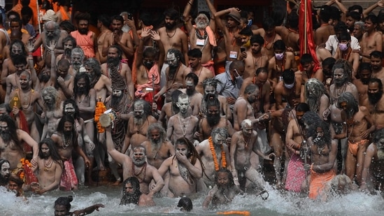 Naga Sadhus (Hindu holy men) take a holy dip in the waters of the Ganges River on the day of Shahi Snan (royal bath) during the ongoing religious Kumbh Mela festival, in Haridwar on April 12, 2021. (AFP)
