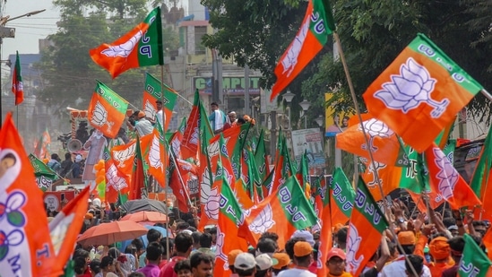 BJP supporters during Union Home Minister Amit Shah's roadshow in support of BJP candidates ahead of the 5th phase of West Bengal Assembly polls in Santipur, Nadia.(PTI)