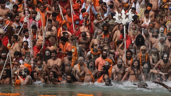 Hindu men take dips in the Ganga River during Kumbh Mela, one of the most sacred pilgrimages in Hinduism, in Haridwar, northern state of Uttarakhand, India, Monday, April 12, 2021. (AP) Hindu men take dips in the Ganga River during Kumbh Mela, one of the most sacred pilgrimages in Hinduism, in Haridwar, northern state of Uttarakhand, India, Monday, April 12, 2021. (AP)