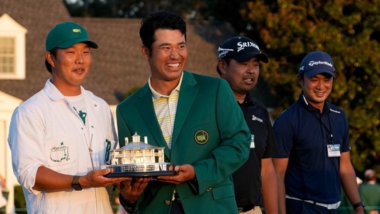 Hideki Matsuyama, of Japan, holds his trophy with his caddie Shota Hayafuji after winning the Masters golf tournament. (AP) Hideki Matsuyama, of Japan, holds his trophy with his caddie Shota Hayafuji after winning the Masters golf tournament. (AP)