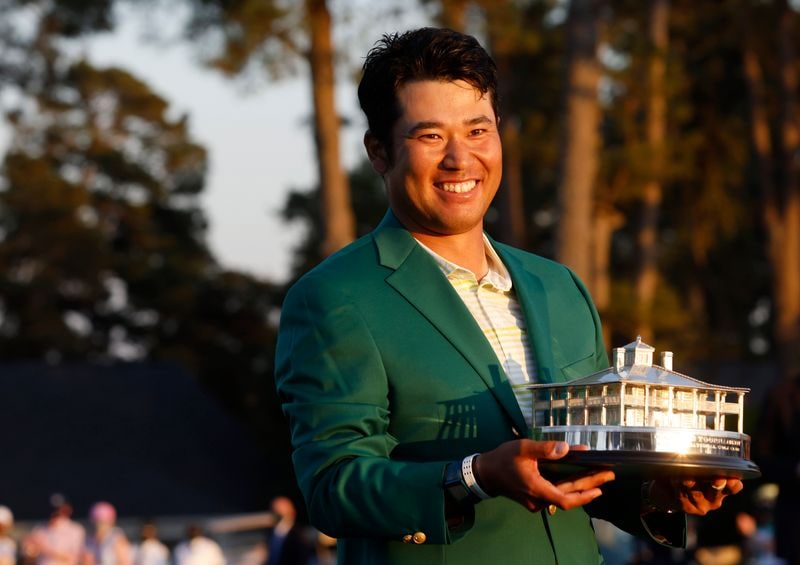 Japan's Hideki Matsuyama celebrates with the green jacket and the trophy after winning The Masters. (REUTERS)