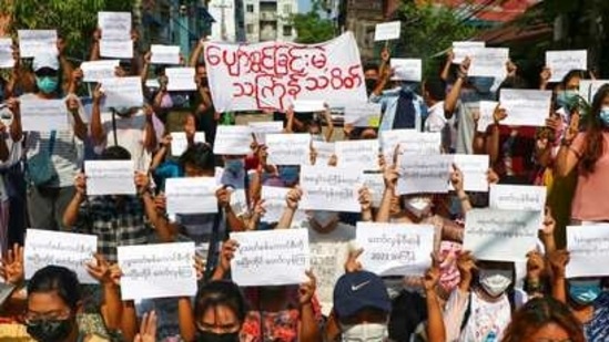 Protesters hold slogans condemning the military government as they mark the Thingyan festival on Tuesday on April 13, 2021 in Yangon, Myanmar. (AP) Protesters hold slogans condemning the military government as they mark the Thingyan festival on Tuesday on April 13, 2021 in Yangon, Myanmar. (AP)