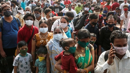 People wearing protective masks stand outside a railway station amidst the spread of the coronavirus disease (Covid-19), in Mumbai, India, April 13, 2021. (Reuters)