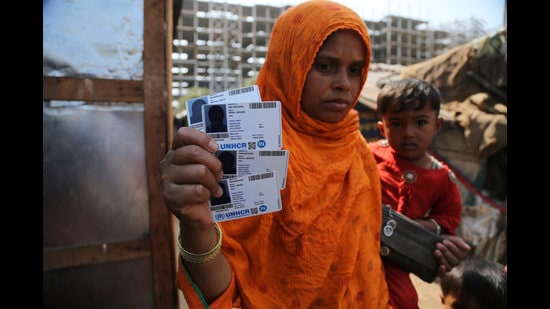 Rahima kato, a Rohingya woman displays identity cards of her family members issued by United Nations High Commissioner for Refugees (UNHCR) at their makeshift camp on the outskirts of Jammu, March 9,2021 (AP) Rahima kato, a Rohingya woman displays identity cards of her family members issued by United Nations High Commissioner for Refugees (UNHCR) at their makeshift camp on the outskirts of Jammu, March 9,2021 (AP)
