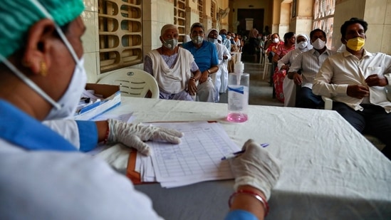 People wait for their turn to be administered COVISHIELD vaccine at a government hospital in Hyderabad, India, Monday, April 12, 2021. With its explosive surge in recent days, India's confirmed infections surpassed Brazil's total Monday as the second-worst hit country. (AP Photo/Mahesh Kumar A.) (AP)