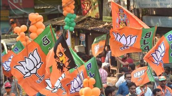 BJP activists with party flags in Kolkata. (PTI)