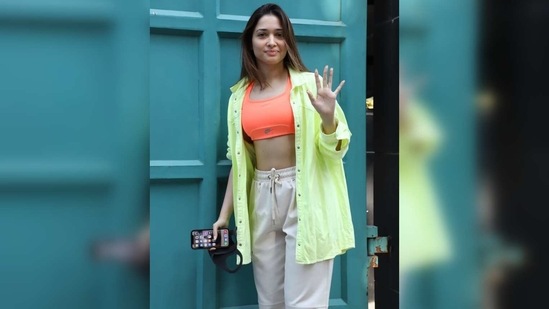 For the day out, Tamannaah wore an tangerine halter-neck sports bra while flaunting her abs.(Varinder Chawla)