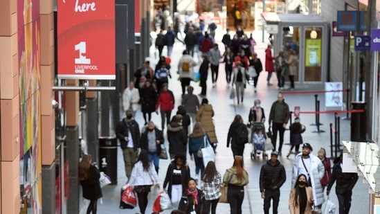 The economy was 7.8 per cent smaller than its pre-pandemic level in February 2020. In picture - People walk past re-opened shops in Liverpool, north west England, as Covid-19 restrictions are eased across the country.(AFP)