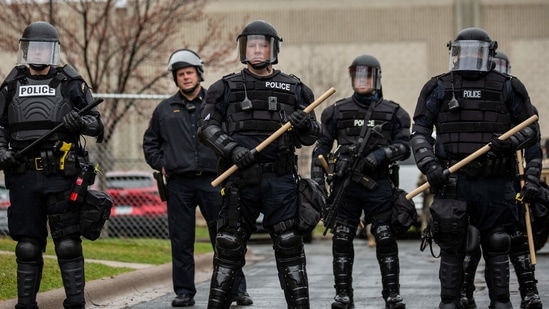 Minnesota Police officers stand guard outside the Brooklyn Center Police Station after a police officer shot and killed a Black man in Brooklyn Center, Minneapolis, Minnesota on April 12, 2021. (AFP)