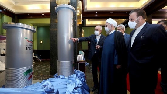 In this April 10, 2021, file photo released by the official website of the office of the Iranian presidency, Iranian President Hassan Rouhani, second from right, listens to the head of the Atomic Energy Organization of Iran Ali Akbar Salehi while visiting an exhibition of Iran's new nuclear achievements in Tehran, Iran. (AP) In this April 10, 2021, file photo released by the official website of the office of the Iranian presidency, Iranian President Hassan Rouhani, second from right, listens to the head of the Atomic Energy Organization of Iran Ali Akbar Salehi while visiting an exhibition of Iran's new nuclear achievements in Tehran, Iran. (AP)