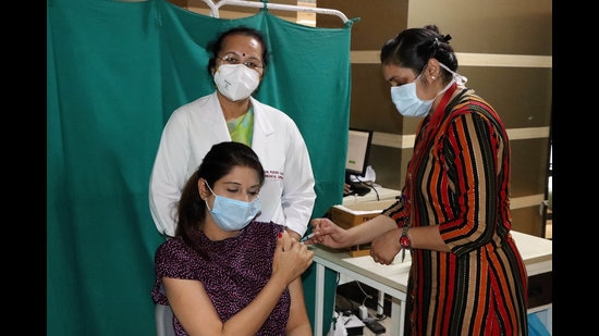 A nurse administering vaccine to a woman at PGIMS in Rohtak on Tuesday. (Manoj Dhaka/HT) A nurse administering vaccine to a woman at PGIMS in Rohtak on Tuesday. (Manoj Dhaka/HT)