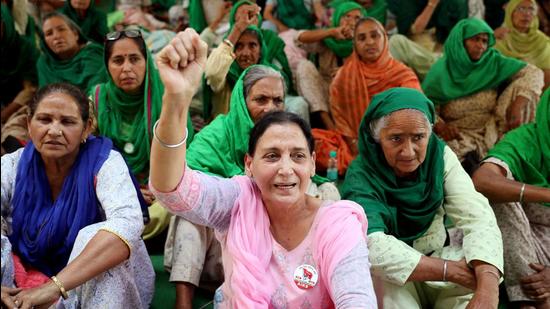 Women farmers shout slogans at a site of a protest against the new farm laws at Singhu border near Delhi on Monday. (ANI) Women farmers shout slogans at a site of a protest against the new farm laws at Singhu border near Delhi on Monday. (ANI)