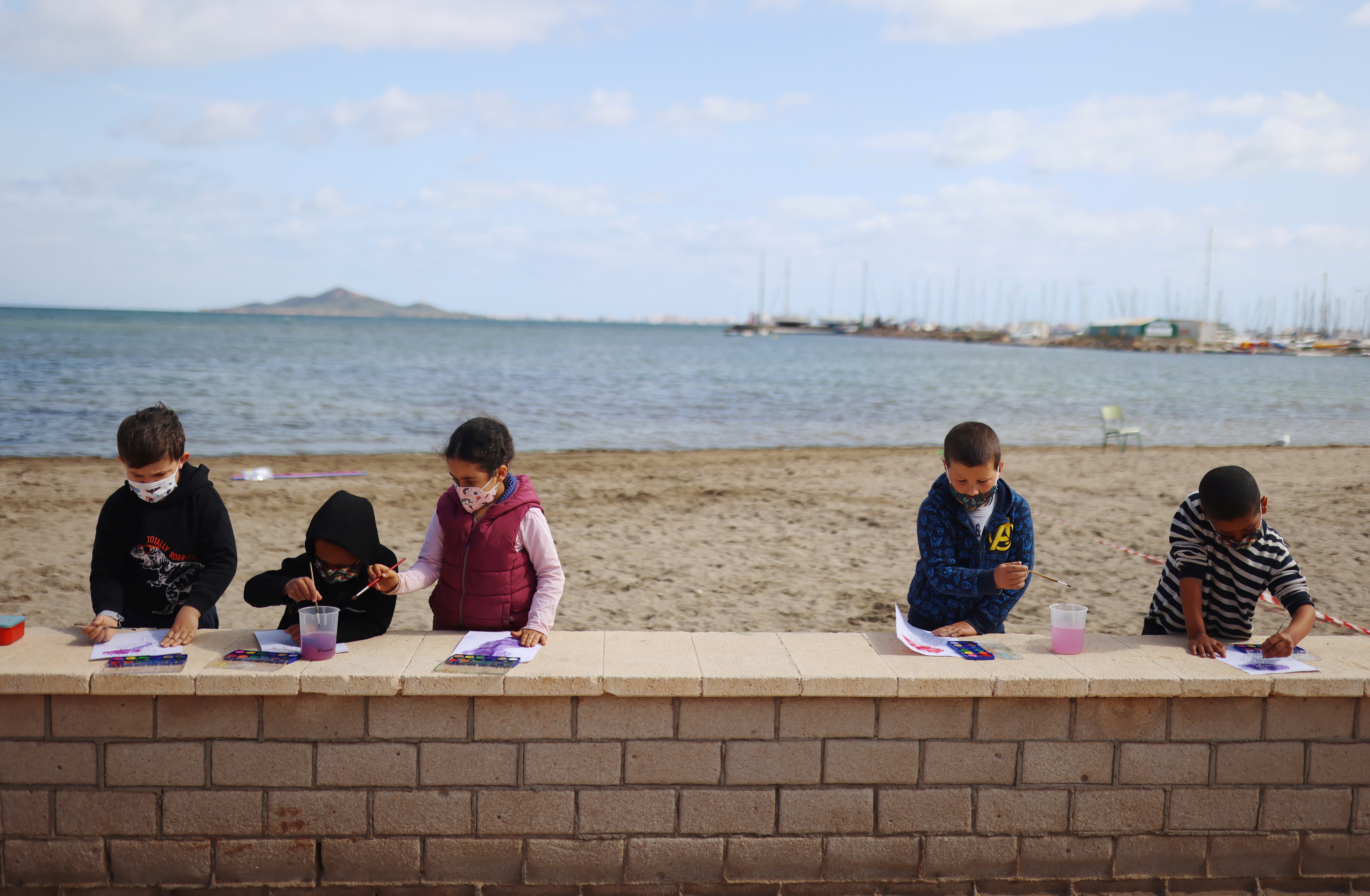 Students of the Felix Rodriguez de la Fuente school paint during a class at the Playa de los Nietos (The Grandchildren's Beach) in Spain. (REUTERS)