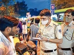 A policeman fines a man for not wearing a mask in Govindpuri market on Wednesday. amal ks/ ht photo