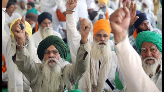 Farmers shout slogans at a site of a protest against the new farm laws at Singhu border near Delhi on Tuesday. (ANI) Farmers shout slogans at a site of a protest against the new farm laws at Singhu border near Delhi on Tuesday. (ANI)