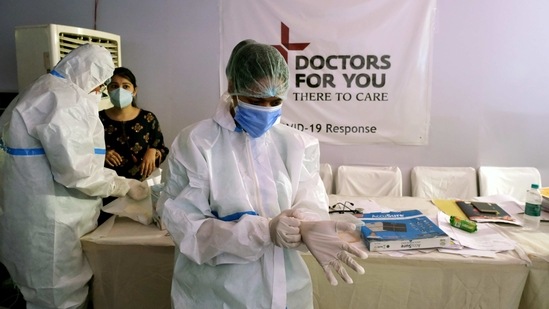 Health workers put on personal protective equipment prior to caring for patients at a makeshift Covid-19 quarantine facility set up in a banquet hall in New Delhi on April 13. Kejriwal also said that plasma stocks to treat Covid-19 patients are running very low and appealed to those who have recovered from the infection to be proactive in donating it, PTI reported. (T Narayan / Bloomberg)