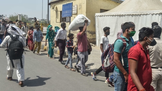 Travellers waiting to be tested for Covid-19 at Anand Vihar Bus Terminal in New Delhi on April 14. The virus has expanded at alarming levels over the past few weeks, at rates faster than the previous three waves of the infection. This forced the state government to impose curbs on travel, schools and gatherings, as well as a curfew between 10pm and 5am till April 30. (Manvender Vashshist / PTI)