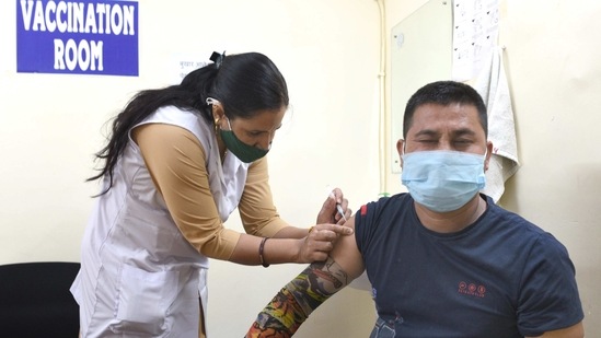 A person being inoculated against Covid-19 at a hospital in Moti Bagh, New Delhi on April 14. According to official records, 7,731 beds have been occupied by Covid-19 patients till April 13 while there were 21,954 people in home isolation in the national capital. (Arvind Yadav / HT Photo)