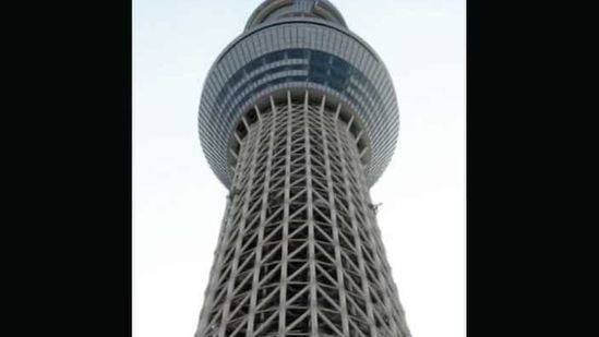 Journalists walk on the foot of the Tokyo Sky Tree, the world's tallest TV tower and second-highest building, in Tokyo. The 634-metre (2080-foot) new landmark in the Japanese capital was opened to the press before the grand opening on May 22. AFP Photo Toru Yamanaka
