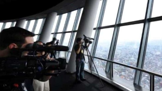 TV cameramen try to shoot a row of buildings and streets from the observatory of the Tokyo Sky Tree, the world's tallest TV tower and second-highest building, in Tokyo. The 634-metre (2080-foot) new landmark in the Japanese capital was opened to the press before the grand opening on May 22. AFP Photo Toru Yamanaka