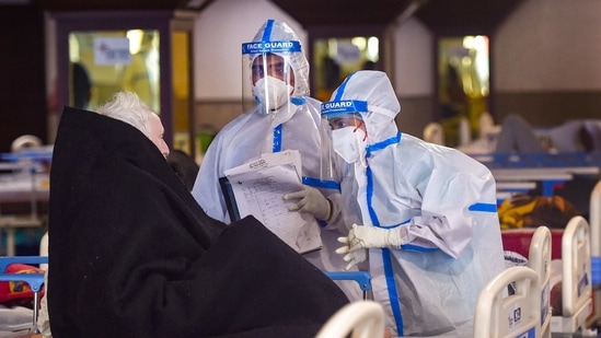 Medics attend to Covid-19 patients at Shehnai Banquet Hall, temporarily converted into an isolation ward, as coronavirus cases surge across the country, near Low Nayak Jai Prakash (LNJP) Hospital in New Delhi on Tuesday.(PTI Photo )