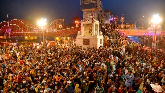 Devotees gather to offer prayers during Ganga aarti at Kumbh Mela, in Haridwar on Tuesday.(PTI Photo)