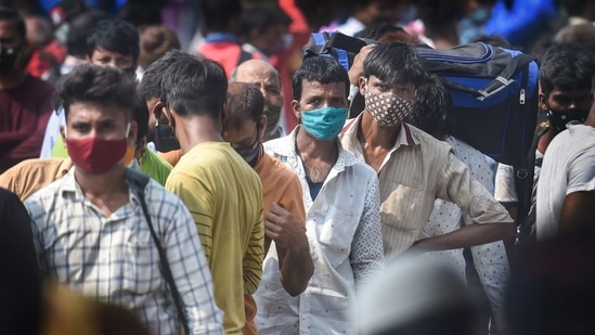 Mumbai: Passengers stand outside the Lokmanya Tilak Terminus to board outstation trains, amid the ongoing spike in Covid-19 cases in Mumbai, Wednesday, April 14, 2021. (PTI) Mumbai: Passengers stand outside the Lokmanya Tilak Terminus to board outstation trains, amid the ongoing spike in Covid-19 cases in Mumbai, Wednesday, April 14, 2021. (PTI)
