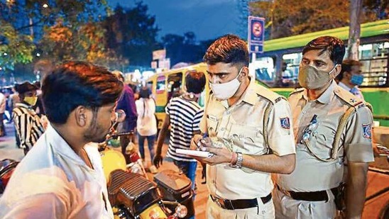A policeman fines a man for not wearing a mask in Govindpuri market on Wednesday. amal ks/ ht photo