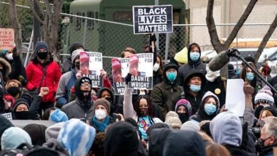 Demonstrators rally outside the Brooklyn Center Police Department to protest the shooting death of Daunte Wright, Tuesday, April 13, 2021, in Brooklyn Center, Minn. (AP Photo/John Minchillo) (AP)