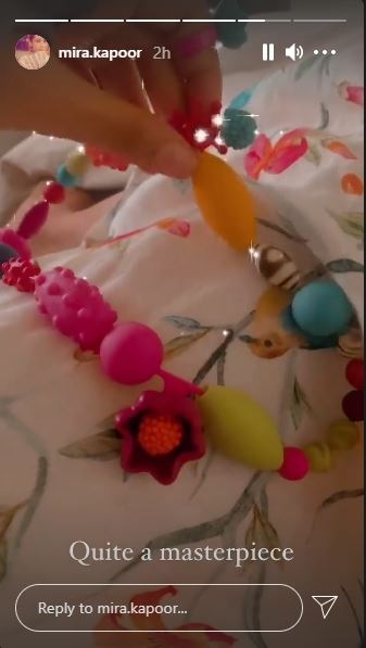 In the second clip, she is seen showing a neckpiece as she writes, "Quite a masterpiece."