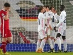 Liverpool's Diogo Jota, left, reacts as Real Madrid players celebrate at the end of the Champions League quarter final second leg soccer match between Liverpool and Real Madrid at Anfield stadium in Liverpool, England, Wednesday, April 14, 2021. Liverpool's Diogo Jota, left, reacts as Real Madrid players celebrate at the end of the Champions League quarter final second leg soccer match between Liverpool and Real Madrid at Anfield stadium in Liverpool, England, Wednesday, April 14, 2021.