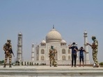 CISF personnel urge tourist to wear mask, at Taj Mahal in this file photo from April 13, 2021. (PTI Photo) CISF personnel urge tourist to wear mask, at Taj Mahal in this file photo from April 13, 2021. (PTI Photo)