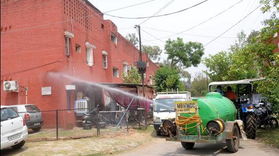 Municipal corporation workers sanitising a residential area near CCET, Sector 26, in Chandigarh on Thursday. (Ravi Kumar/HT) Municipal corporation workers sanitising a residential area near CCET, Sector 26, in Chandigarh on Thursday. (Ravi Kumar/HT)