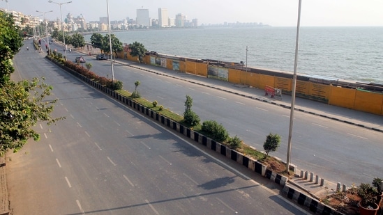 A deserted view of Marine Drive road after the Maharashtra government imposed restrictions to curb the COVID-19 cases, in Mumbai on Thursday. (ANI Photo) A deserted view of Marine Drive road after the Maharashtra government imposed restrictions to curb the COVID-19 cases, in Mumbai on Thursday. (ANI Photo)