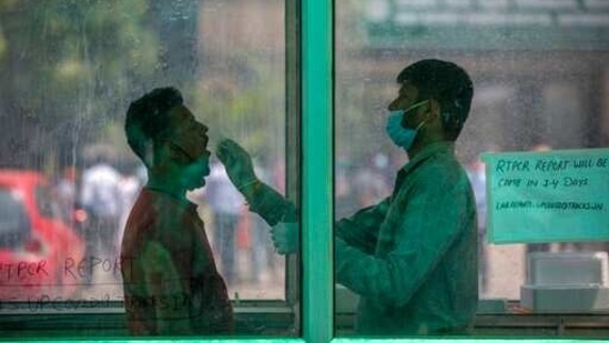 A health worker takes a swab sample to test for COVID-19 at a government hospital in Noida, a suburb of New Delhi, India, Thursday, April 15, 2021. India reported more than 200,000 new coronavirus cases Thursday, skyrocketing past 14 million overall as an intensifying outbreak puts a grim weight on its fragile health care system. (AP Photo/Altaf Qadri) (AP) A health worker takes a swab sample to test for COVID-19 at a government hospital in Noida, a suburb of New Delhi, India, Thursday, April 15, 2021. India reported more than 200,000 new coronavirus cases Thursday, skyrocketing past 14 million overall as an intensifying outbreak puts a grim weight on its fragile health care system. (AP Photo/Altaf Qadri) (AP)