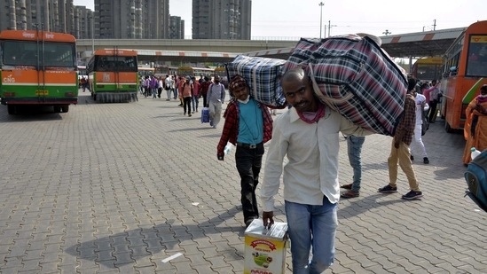 Migrant workers and other travellers leaving the city as Covid-19 cases in the NCR region rise, at Kaushambi Bus Terminal in Ghaziabad on April 14. In recent days, increased numbers of migrant workers fearing the return of lockdown like situations from last year have been seen at railway stations and bus terminals(Sakib Ali / HT Photo)