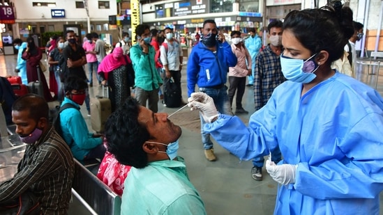 Travellers at Chhatrapati Shivaji Maharaj Terminus (CSMT) railway station being screened for Covid-19 in Mumbai. Despite injecting about 114 million vaccine doses, the highest figure worldwide after the United States and China, India has covered only a small part of its 1.4 billion people.(Bhushan Koyande / HT Photo)