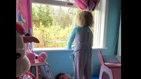 The image shows Abby standing in front of a window, (Instagram/@alongcameabby) The image shows Abby standing in front of a window, (Instagram/@alongcameabby)